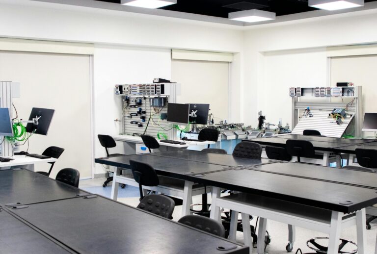 Academics Spacious and modern technology lab featuring desks and computer equipment, ideal for educational settings.